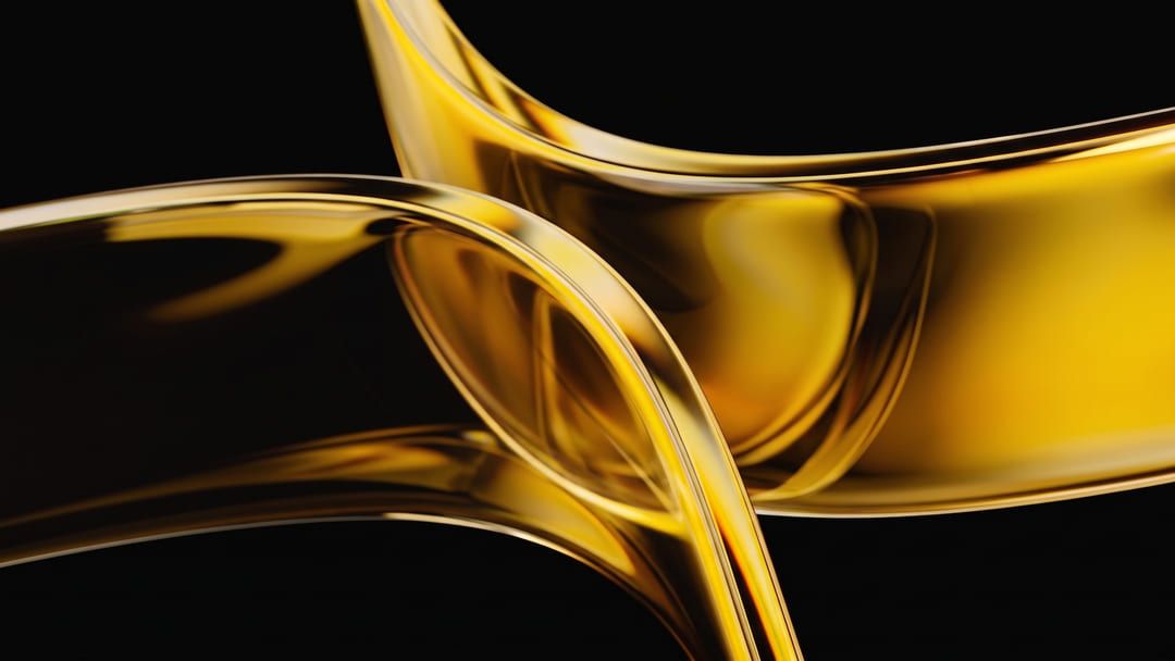 Ribbons of amber glass curving through darkness